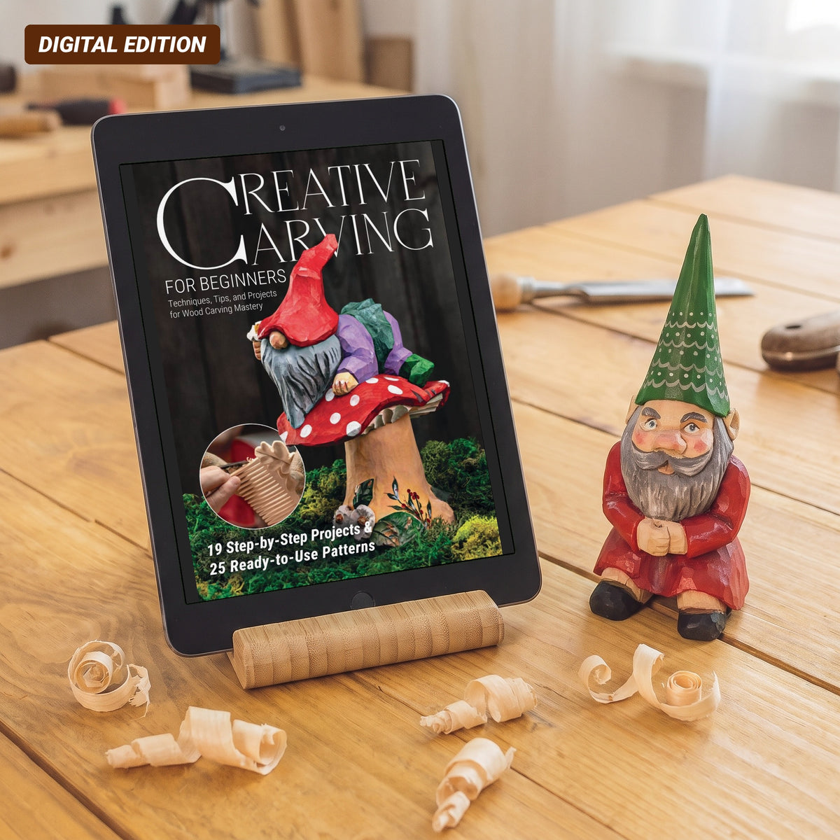 Creative Carving for Beginners digital magazine cover on a tablet next to a carved garden gnome on a workbench